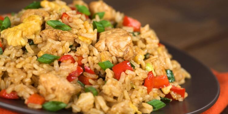 Arroz preguiçoso combina arroz cru, creme de leite, molho de tomate, legumes e proteína em preparo único no forno