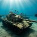 Tanques de guerra blindados alinhados no fundo arenoso do Mar Vermelho com mergulhadores e peixes ao redor