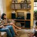 Criança ouve em casa músicas antigas escolhidas pelos pais durante uma tarde em família.