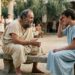 Representação de Sócrates conversando com o jovem Cármides após uma queixa de dor de cabeça na Atenas clássica.