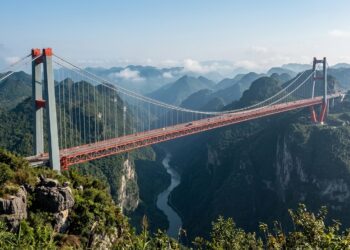 Ponte do Grande Cânion de Huajiang, na China, atravessando um vale profundo entre montanhas.