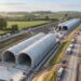 Vista aérea ilustrativa do túnel verde de Chipping Warden, com dois arcos paralelos de concreto pré-moldado montados em uma trincheira na Inglaterra.